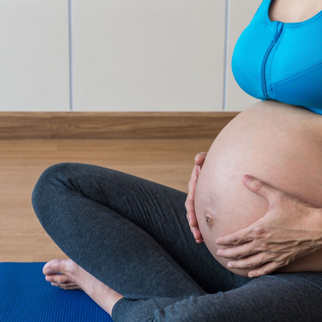 closeup-asian-pregnant-female-do-exercise-in-sport-VJLKTFK